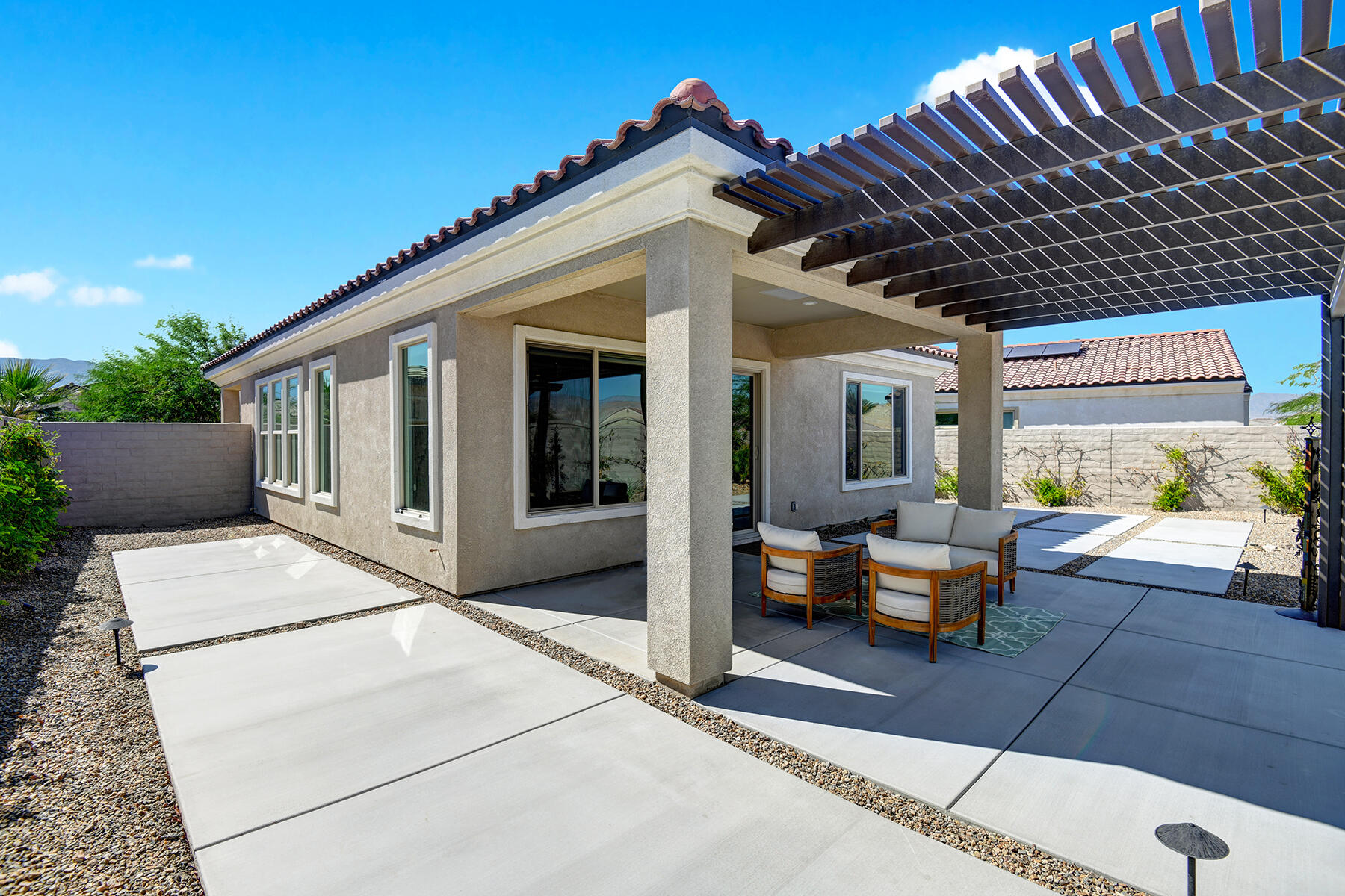 58 Claret Road Rancho Mirage, CA 92270 - Photo 19 of 33 a view of a patio with couches table and chairs and potted plants