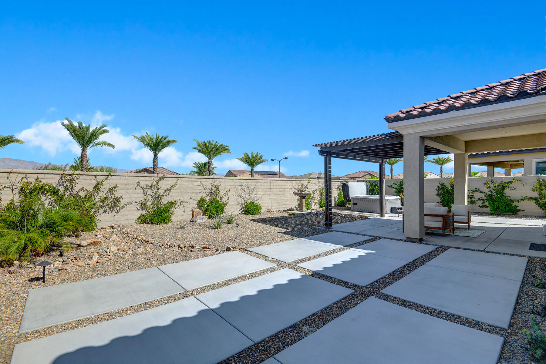58 Claret Road Rancho Mirage, CA 92270 - Photo 21 of 33 a view of a patio with a table and chairs under an umbrella