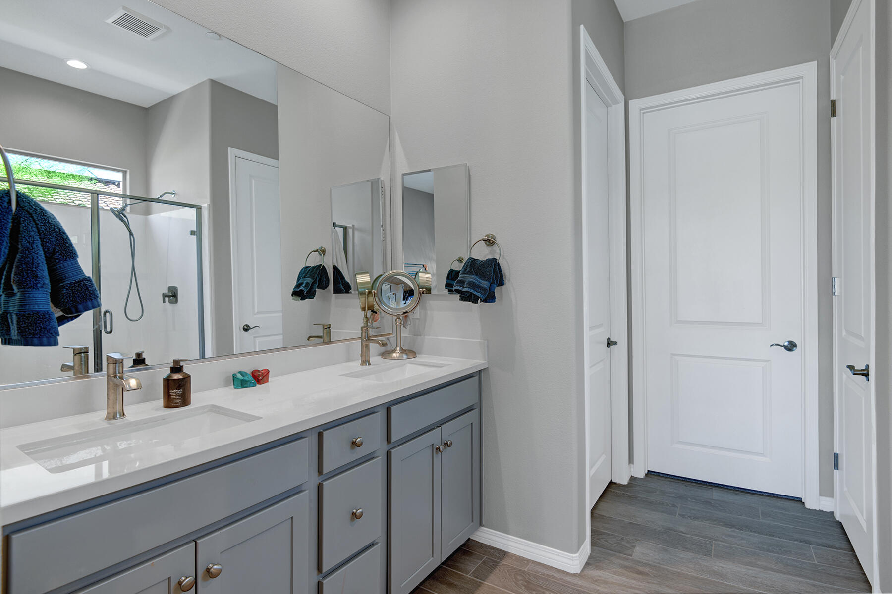 58 Claret Road Rancho Mirage, CA 92270 - Photo 24 of 33 a bathroom with a double vanity sink and mirror