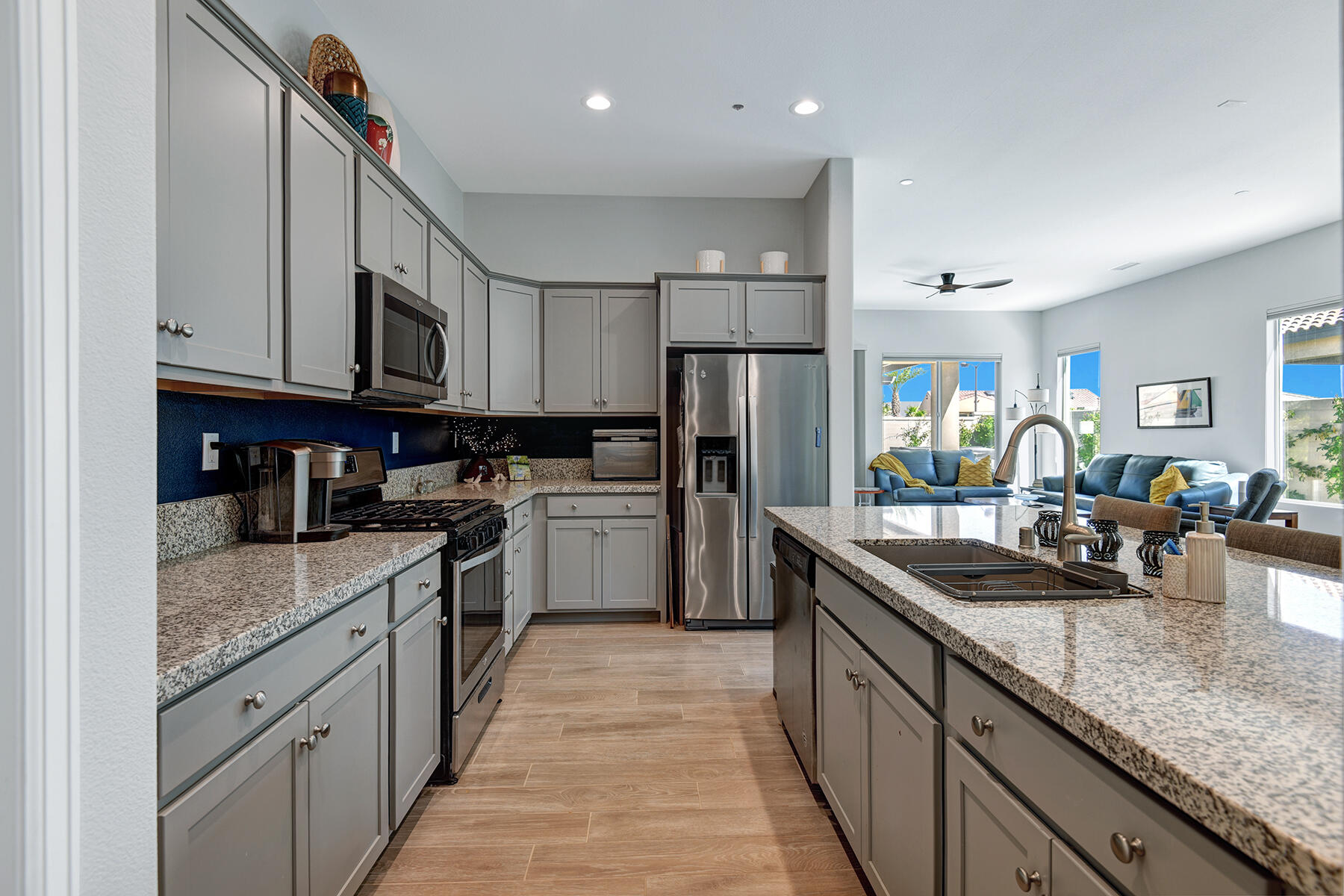 58 Claret Road Rancho Mirage, CA 92270 - Photo 5 of 33 a kitchen with stainless steel appliances granite countertop a sink a stove and a refrigerator