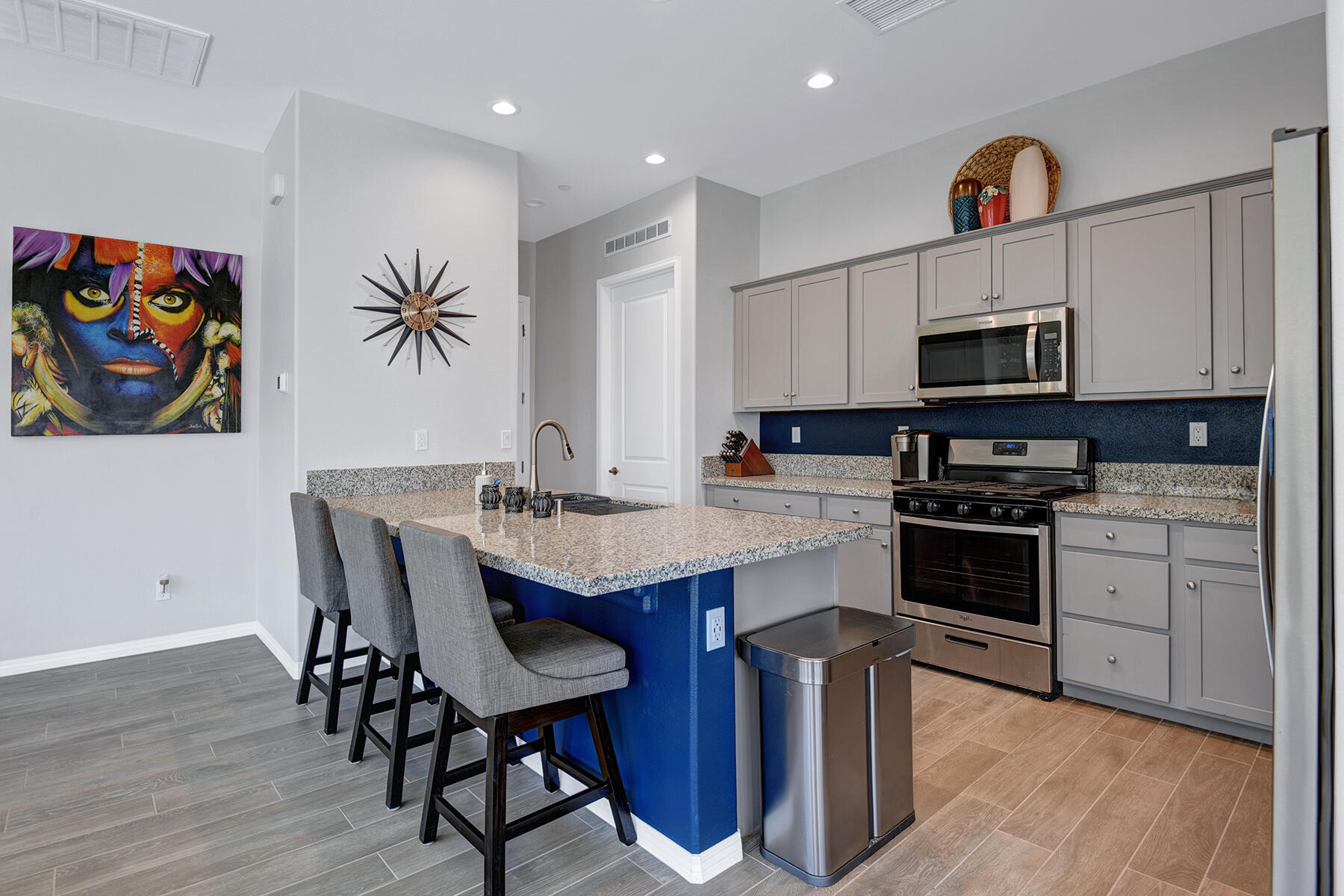 58 Claret Road Rancho Mirage, CA 92270 - Photo 7 of 33 a kitchen with stainless steel appliances granite countertop a kitchen island hardwood floor sink and stove
