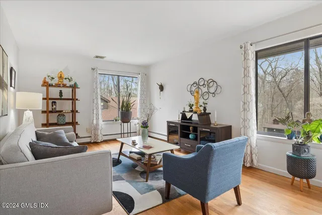 a living room with furniture a chandelier and a table