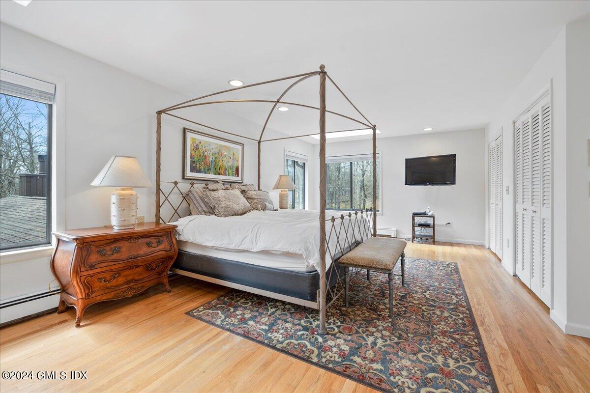 693 Den Road Stamford, CT 06903 - Photo 18 of 32 a bedroom with a bed window and a table