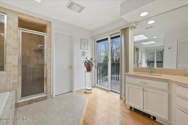 a spacious bathroom with a shower and a sink