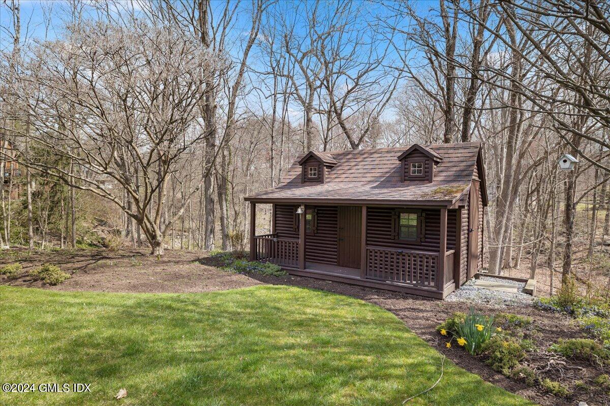 693 Den Road Stamford, CT 06903 - Photo 21 of 32 a front view of a house with a garden