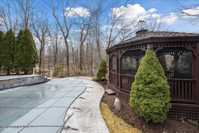 a view of entrance gate of house and trees