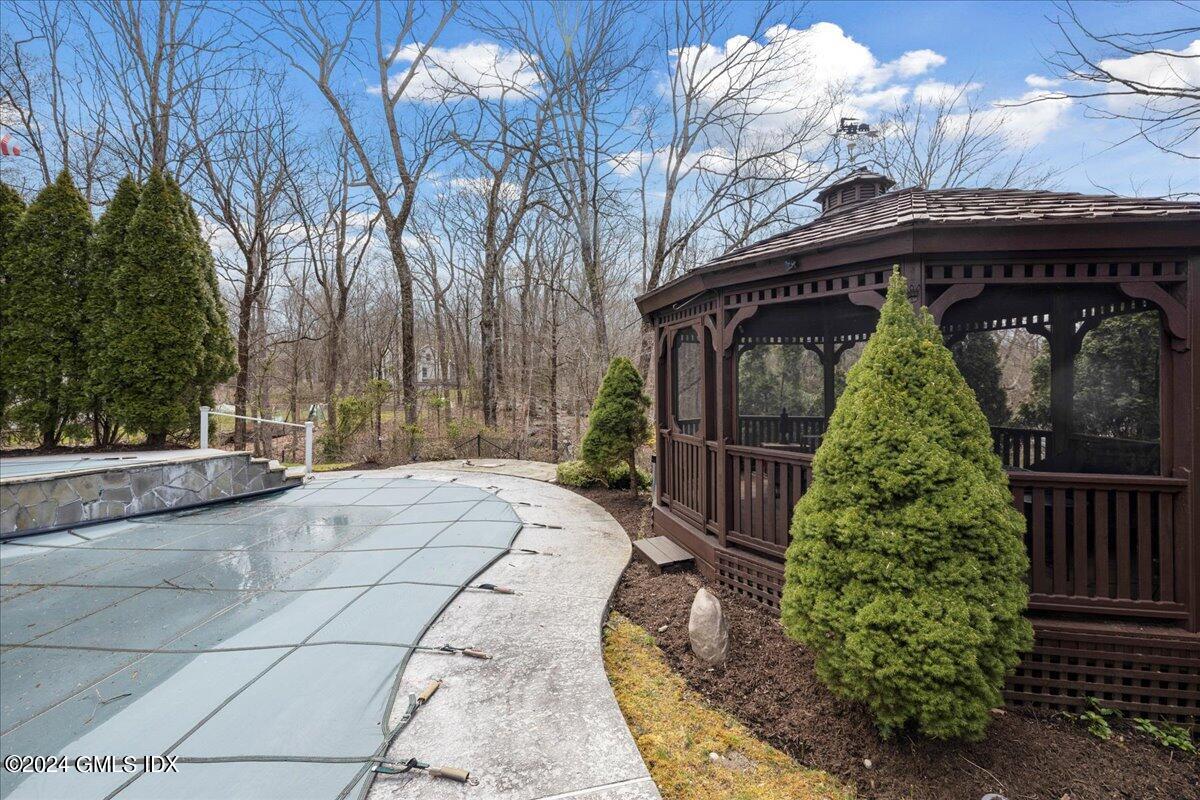 693 Den Road Stamford, CT 06903 - Photo 23 of 32 a view of entrance gate of house and trees