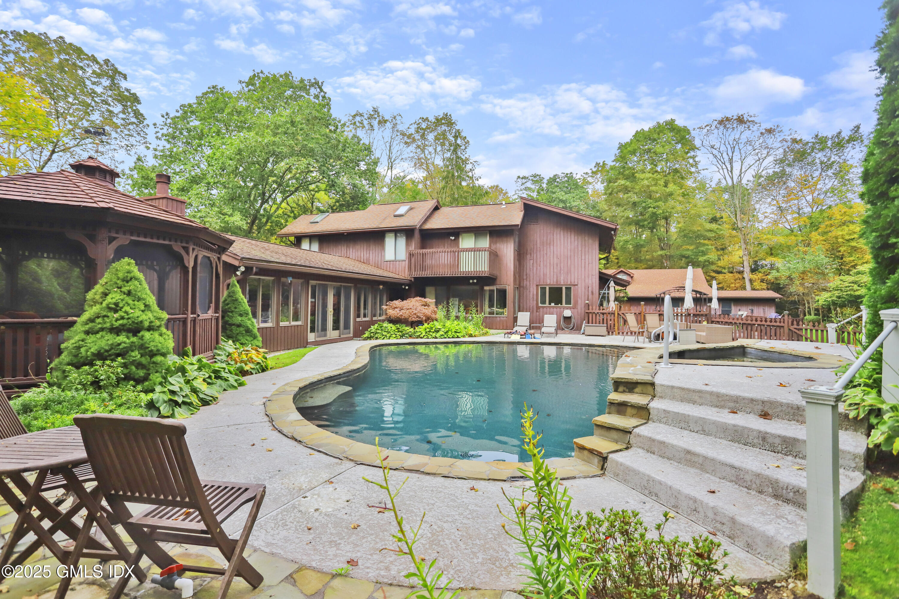 693 Den Road Stamford, CT 06903 - Photo 26 of 32 a view of a swimming pool with a patio
