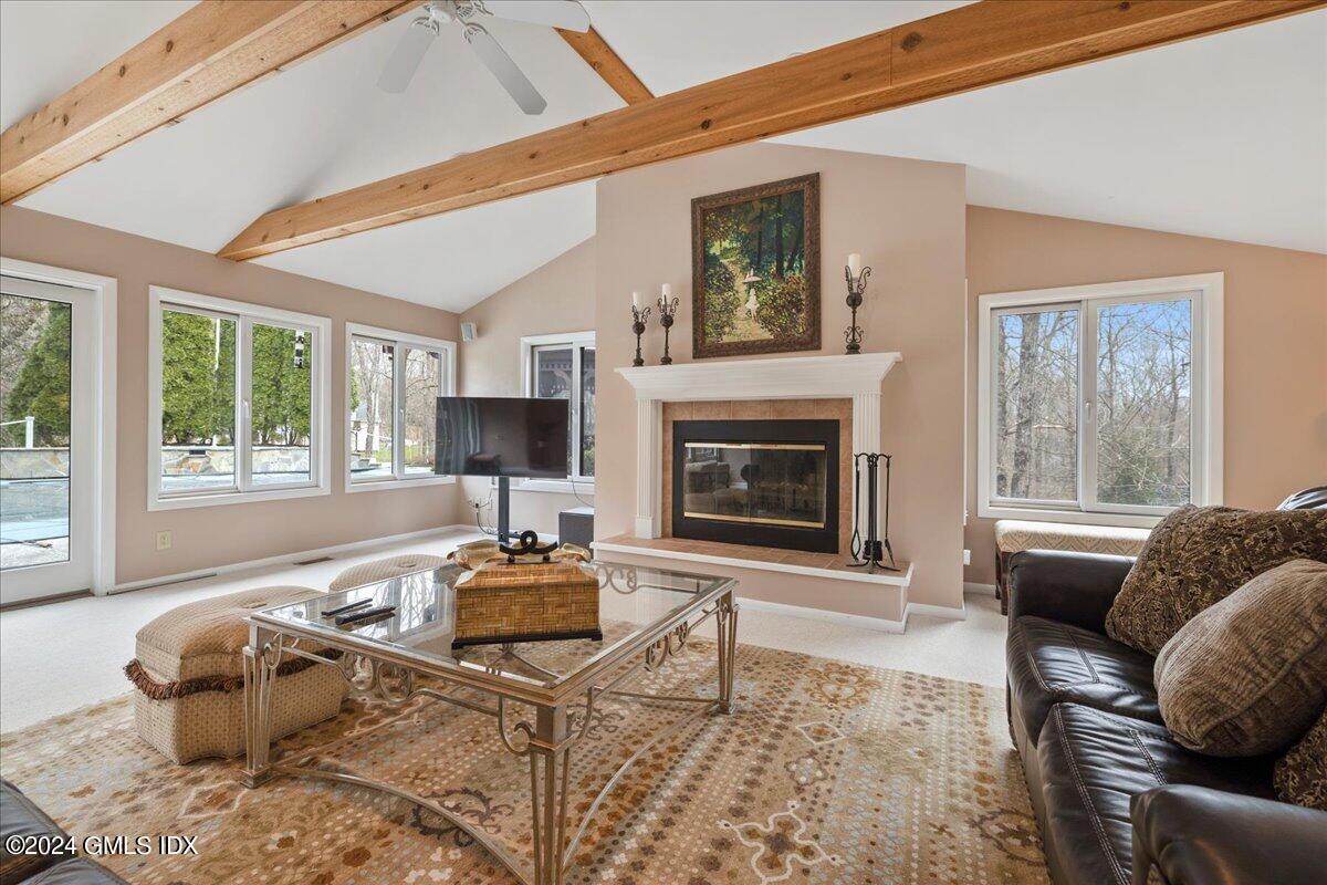 693 Den Road Stamford, CT 06903 - Photo 3 of 32 a living room with furniture a flat screen tv and a fireplace