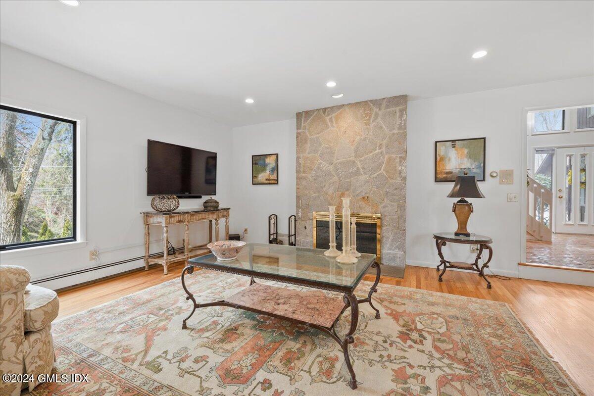693 Den Road Stamford, CT 06903 - Photo 6 of 32 a living room with furniture and a flat screen tv with wooden floor