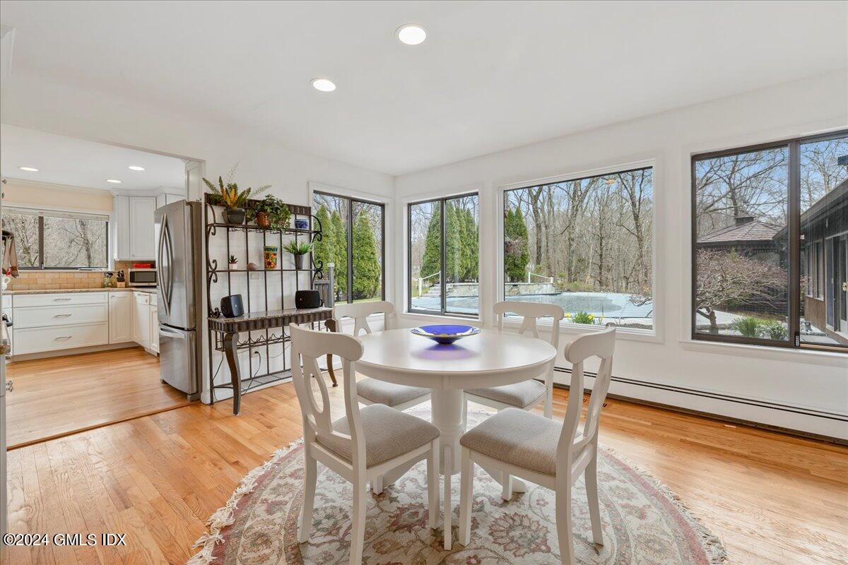 693 Den Road Stamford, CT 06903 - Photo 10 of 32 a dining room with furniture and floor to ceiling windows