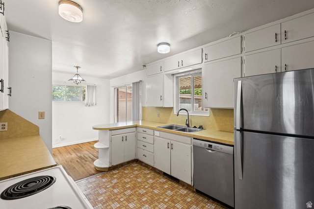 542 East 3400th Street North Provo, UT 84604 - Photo 14 of 39 Kitchen with white cabinetry, light countertops, and a dual-basin sink with a gooseneck faucet