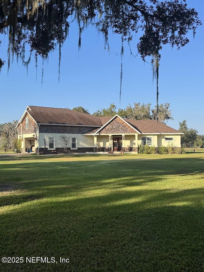 8995 Barrel Factory Road Hastings, FL 32145 - Photo 1 of 23 a front view of a house with a garden
