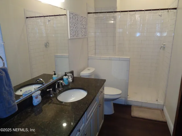 a bathroom with a sink toilet and shower