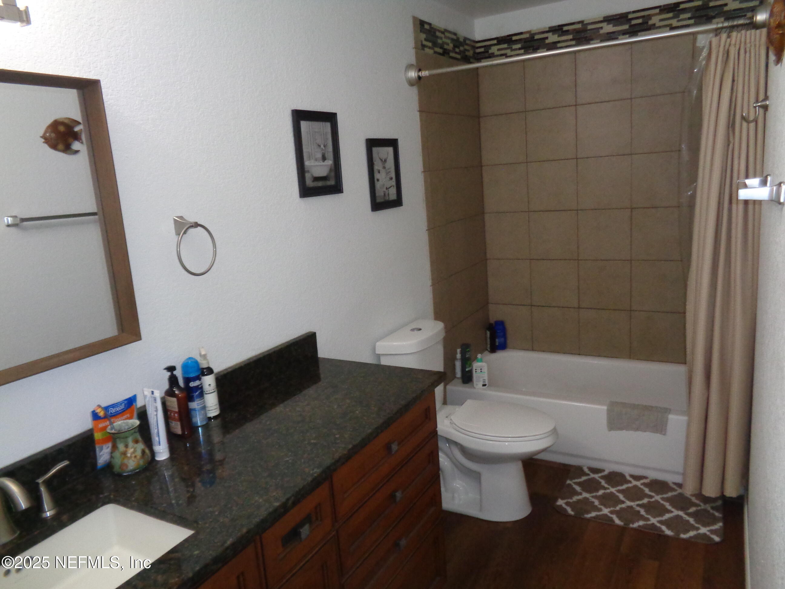 8995 Barrel Factory Road Hastings, FL 32145 - Photo 16 of 23 a white toilet sitting next to a bathroom sink and a shower