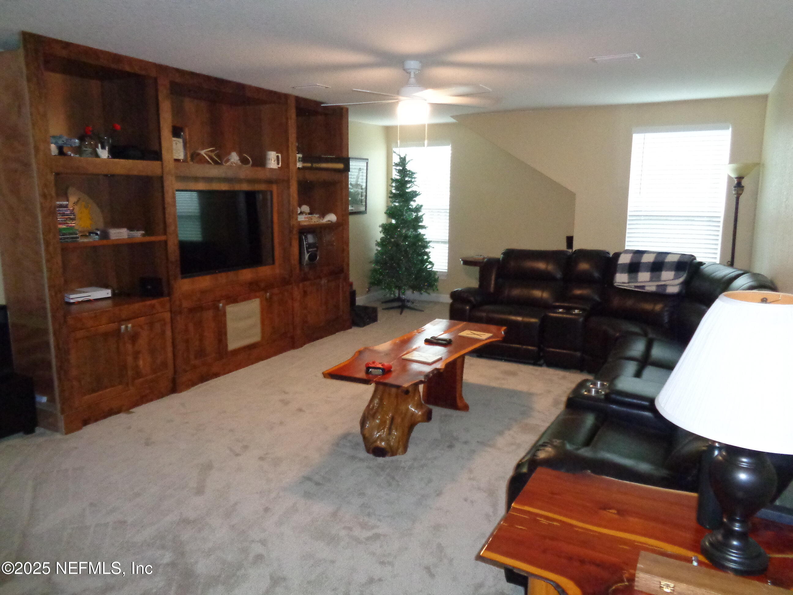 8995 Barrel Factory Road Hastings, FL 32145 - Photo 17 of 23 a living room with furniture a rug and a bookshelf