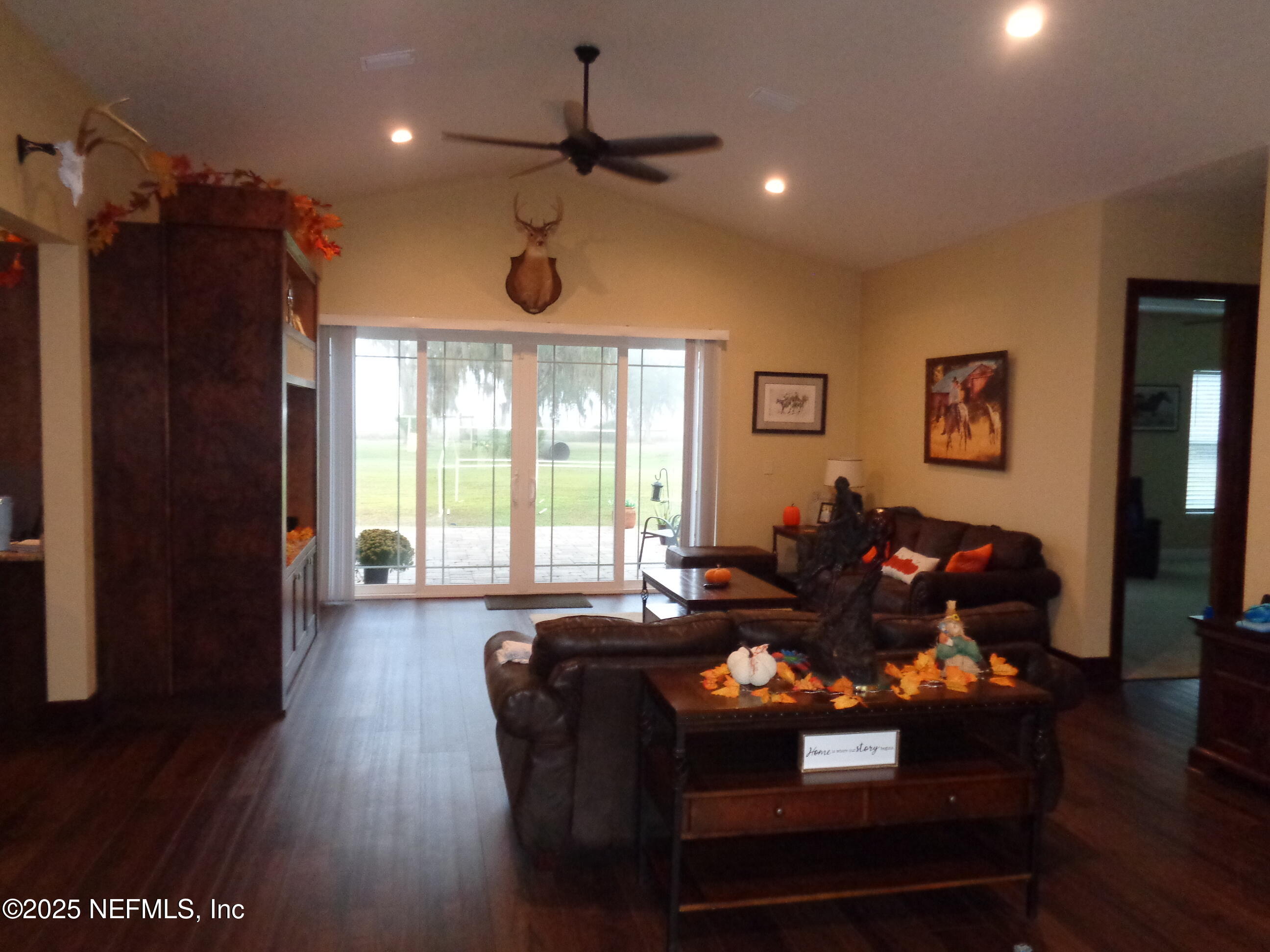 8995 Barrel Factory Road Hastings, FL 32145 - Photo 19 of 23 a living room with furniture windows and a chandelier