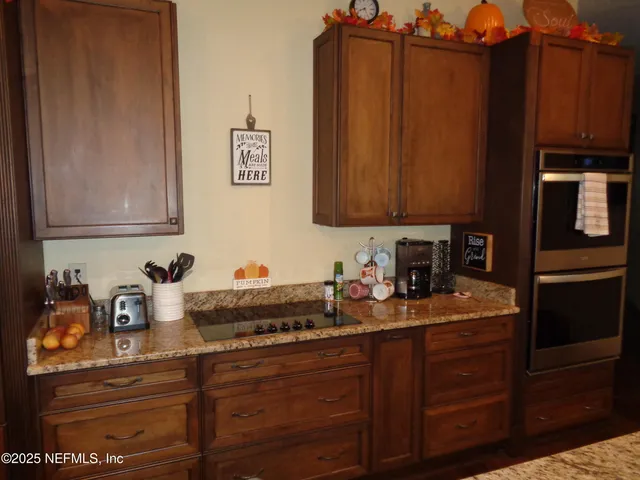a kitchen with sink cabinets and appliances