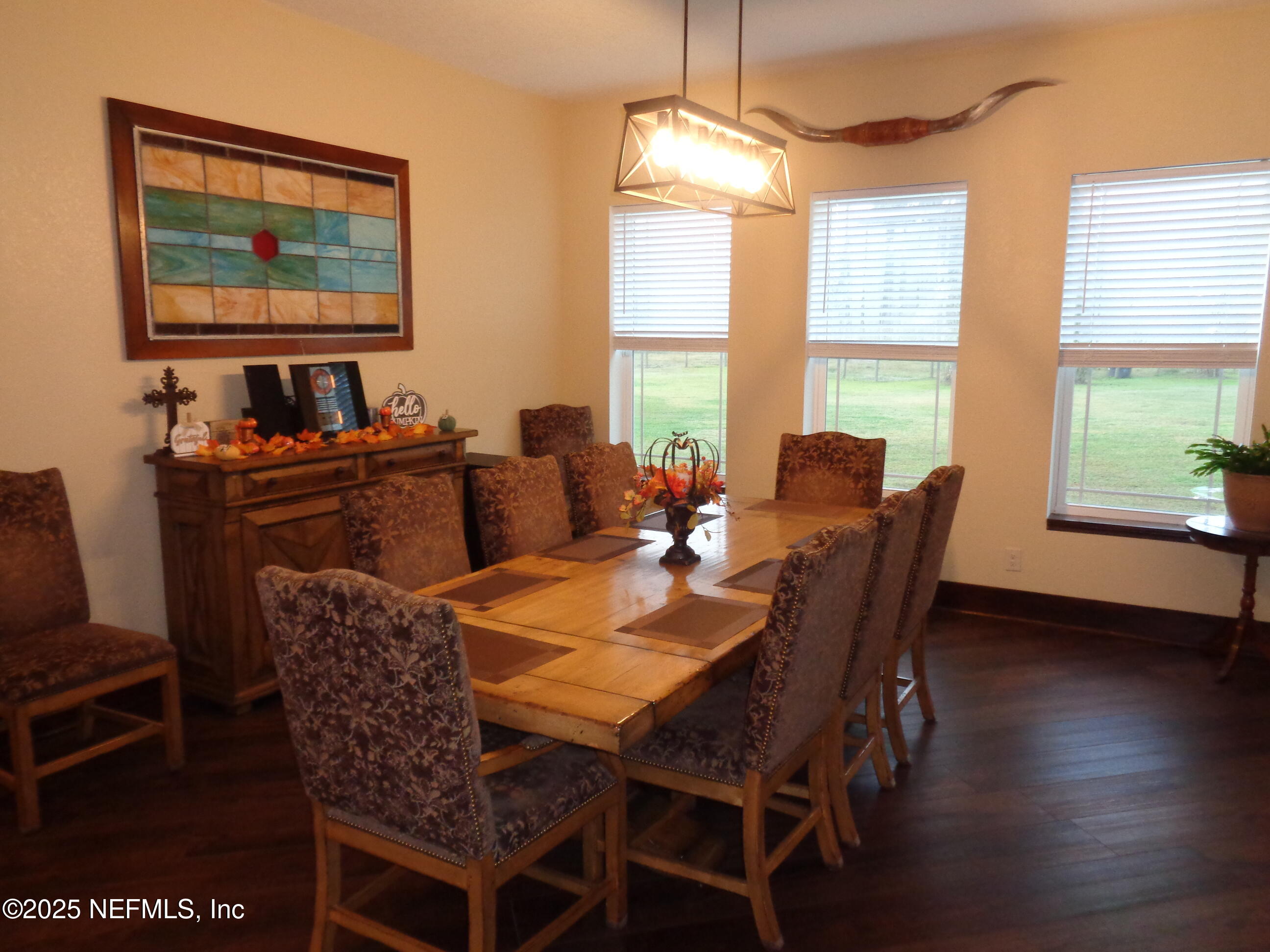 8995 Barrel Factory Road Hastings, FL 32145 - Photo 6 of 23 a view of a dining room with furniture window and wooden floor
