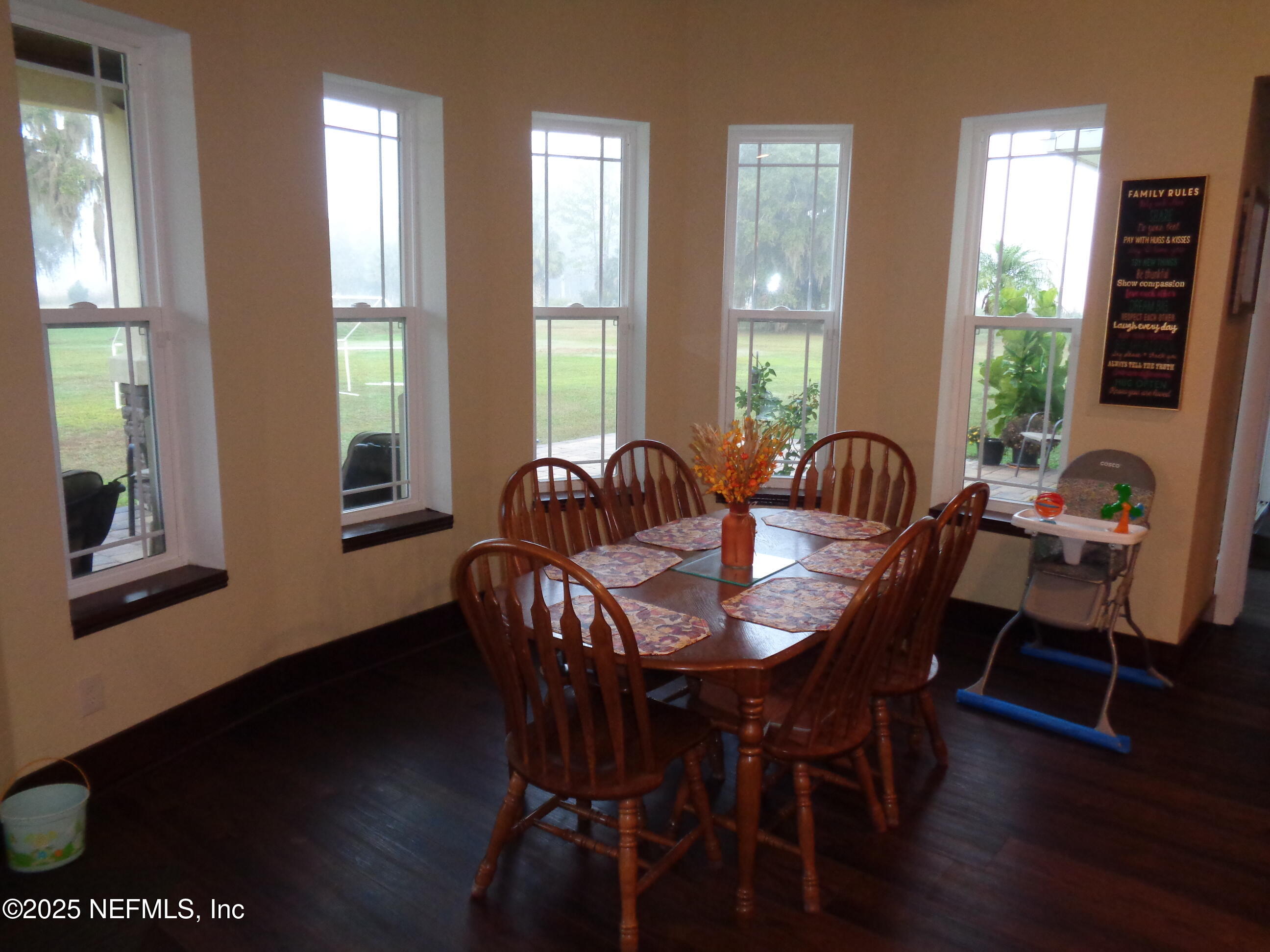 8995 Barrel Factory Road Hastings, FL 32145 - Photo 7 of 23 a view of a dining room with furniture and wooden floor