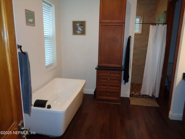 a bathroom with a bathtub and a shower