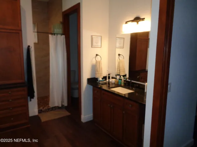 a bathroom with a double vanity sink and a mirror