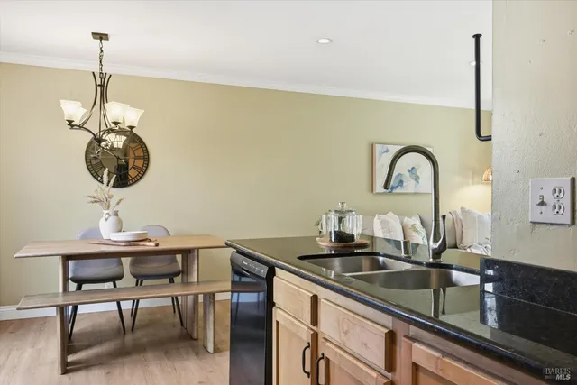 a kitchen with a sink and chandelier