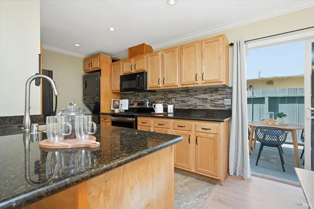 a kitchen with stainless steel appliances granite countertop a sink and a microwave