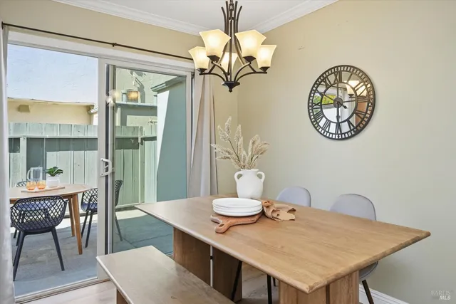 a view of a dining room with furniture and chandelier