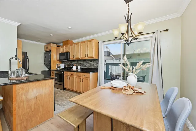 a kitchen with granite countertop a sink appliances and cabinets
