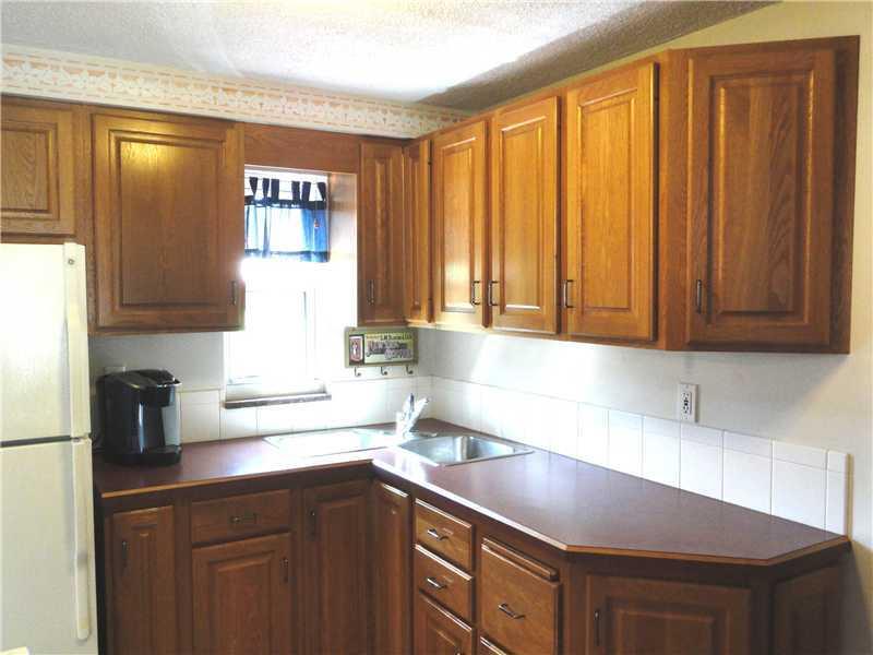 1937 Bower Hill Road Pittsburgh, PA 15243 - Photo 9 of 24 Kitchen. The 10 x 8 kitchen boasts of oak cabinetry and a window that over looks the private back yard. The refrigerator and electric range are staying with this home. There is neutral ceramic tile flooring.