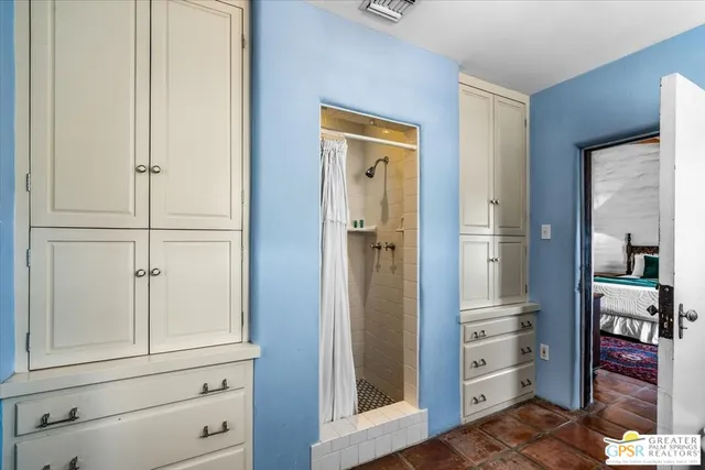 wooden floor with cabinet and mirror