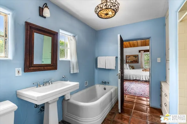 a bathroom with a toilet sink and mirror