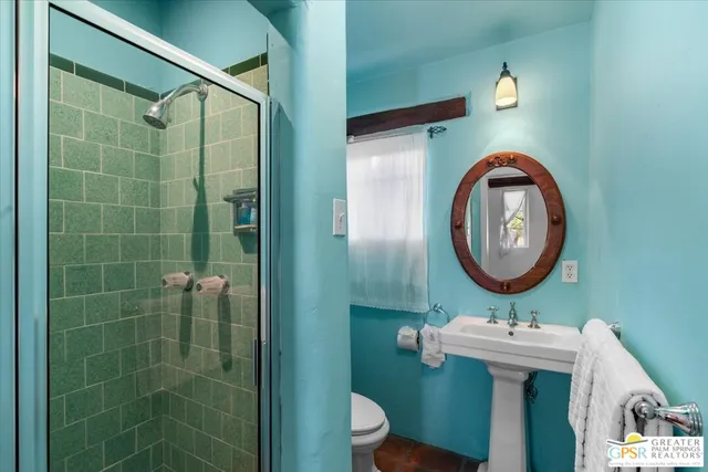 a bathroom with a sink a toilet and a shower