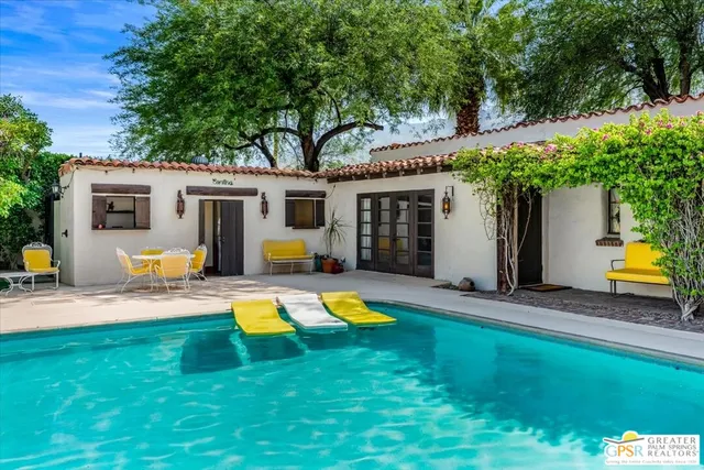 a view of a house with backyard and swimming pool