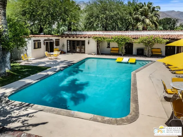 a view of a swimming pool with an outdoor seating