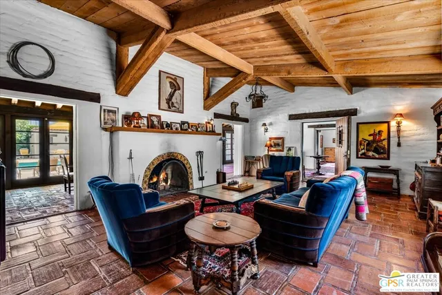 a living room with furniture a fireplace and a table