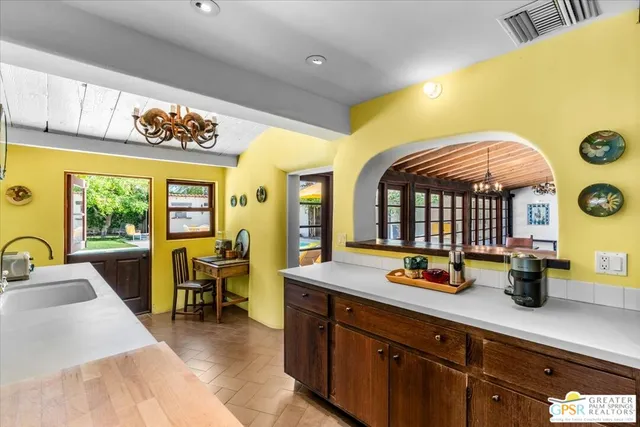 a large kitchen with a table and chairs