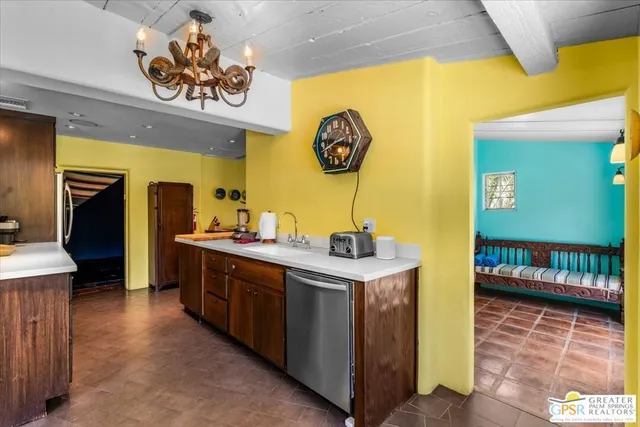 a kitchen with a sink and a stove top oven