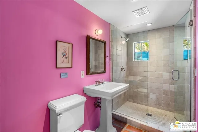 a bathroom with a sink shower and a mirror