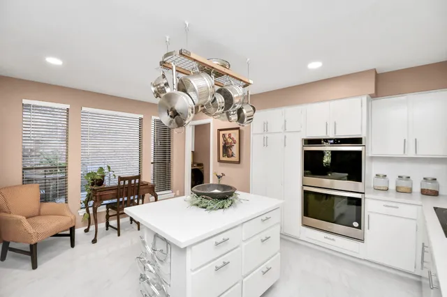 a kitchen with a sink stainless steel appliances and cabinets