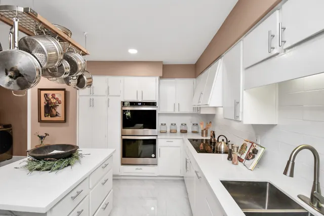 a kitchen with a sink a stove and cabinets