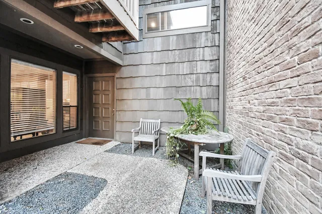 a backyard of a house with table and chairs