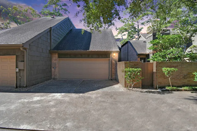 front view of a house with a yard and a garage