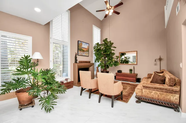 a living room with furniture and a potted plant