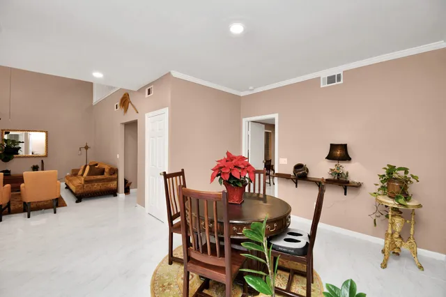 a view of a dining room with furniture and a chandelier