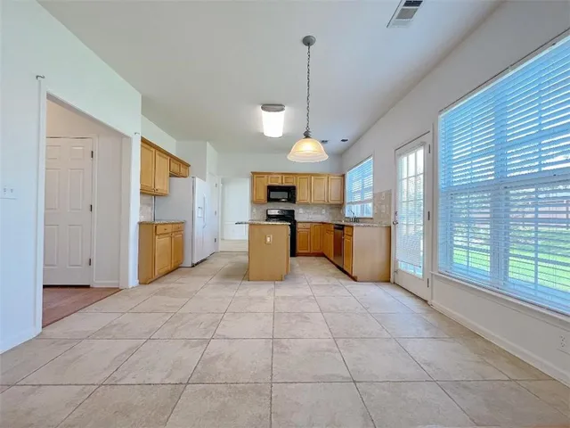 a large kitchen with cabinets and stainless steel appliances