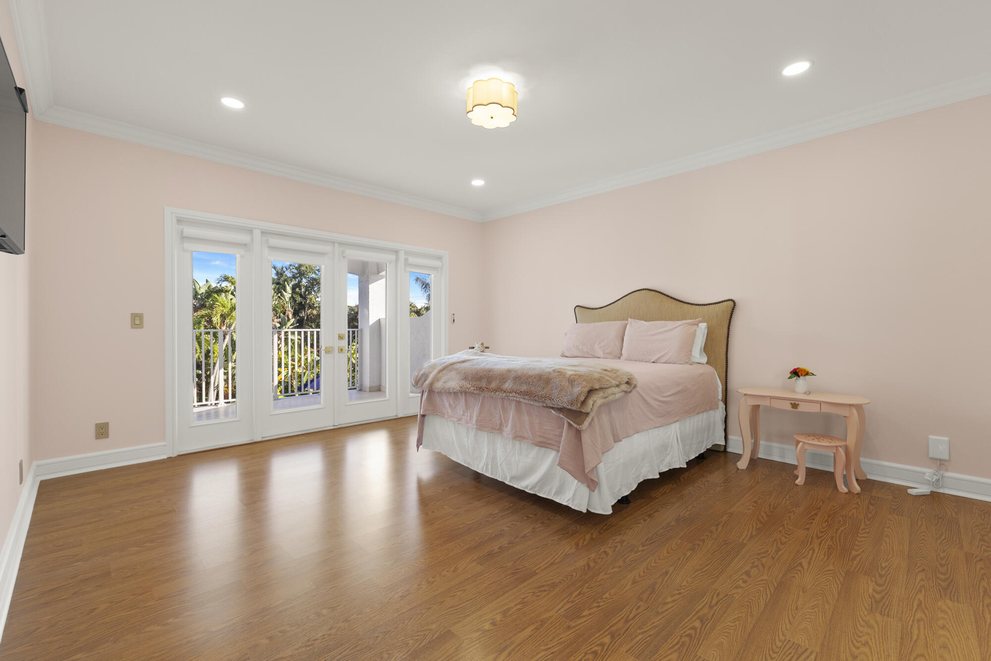 325 Eagle Drive Jupiter, FL 33477 - Photo 22 of 51 a bedroom with a bed and wooden floor