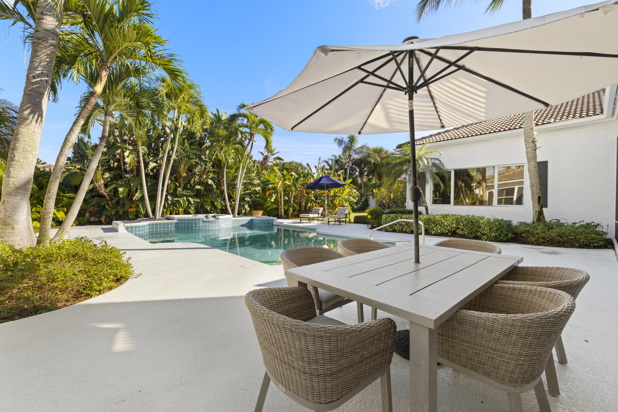 325 Eagle Drive Jupiter, FL 33477 - Photo 3 of 51 a patio with a table and chairs