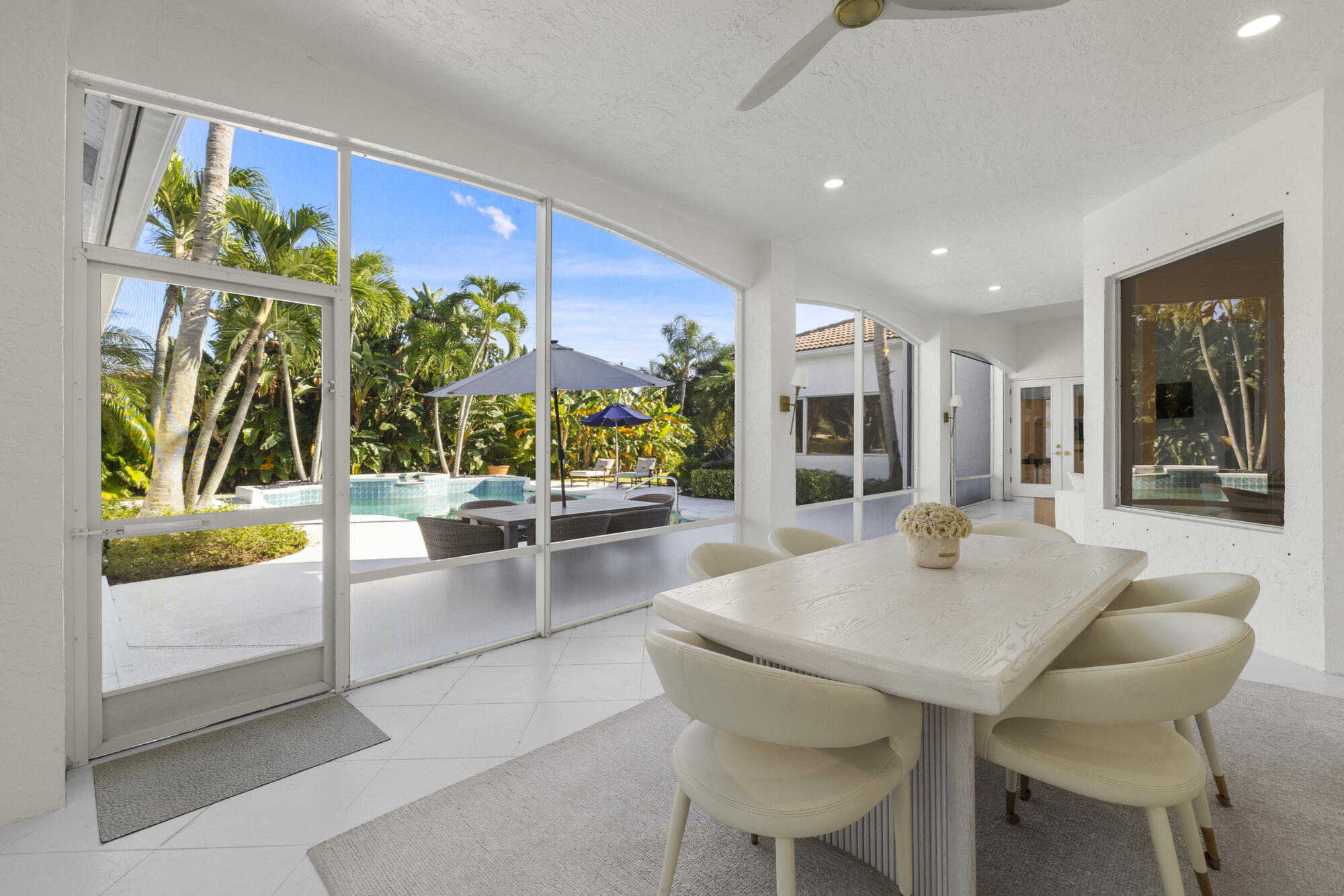 325 Eagle Drive Jupiter, FL 33477 - Photo 6 of 51 a view of a dining room with furniture and a potted plant